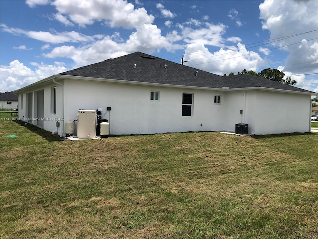 4568/4570 Golfview Blvd, Lehigh Acres, FL 33973 - rear view of property with stucco siding and a yard