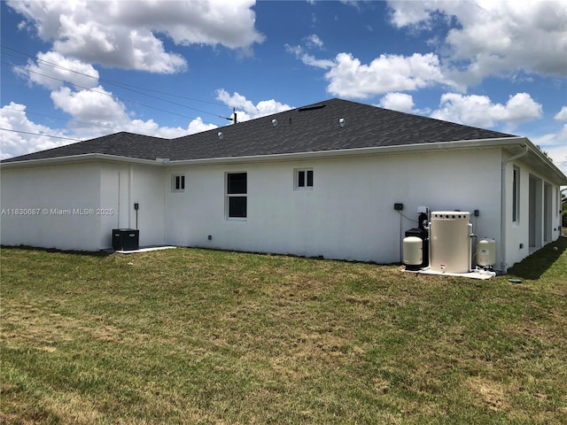 4568/4570 Golfview Blvd, Lehigh Acres, FL 33973 - rear view of property featuring stucco siding, a yard, and roof with shingles