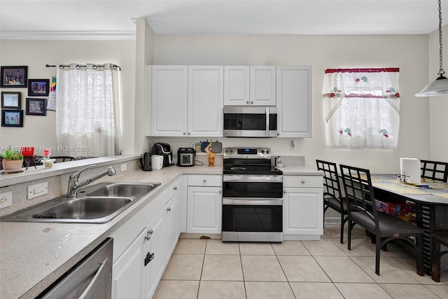 7095 E Tropical Way, Plantation, FL 33317 - kitchen with stainless steel appliances, white cabinetry, light tile patterned floors, light countertops, and crown molding