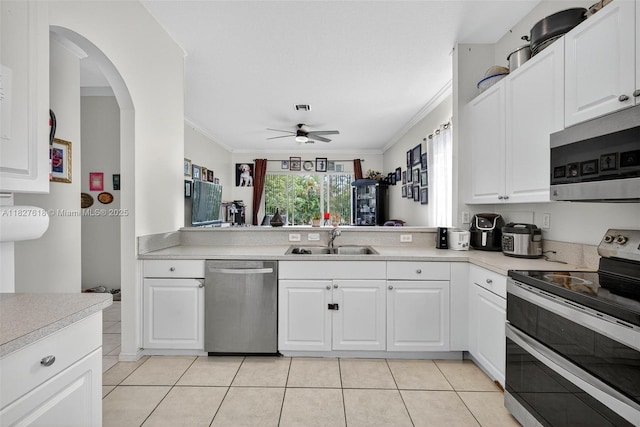 7095 E Tropical Way, Plantation, FL 33317 - kitchen featuring stainless steel appliances, crown molding, ceiling fan, light countertops, and light tile patterned flooring