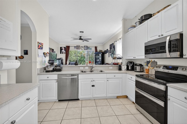 7095 E Tropical Way, Plantation, FL 33317 - kitchen with stainless steel appliances, crown molding, light countertops, ceiling fan, and light tile patterned flooring