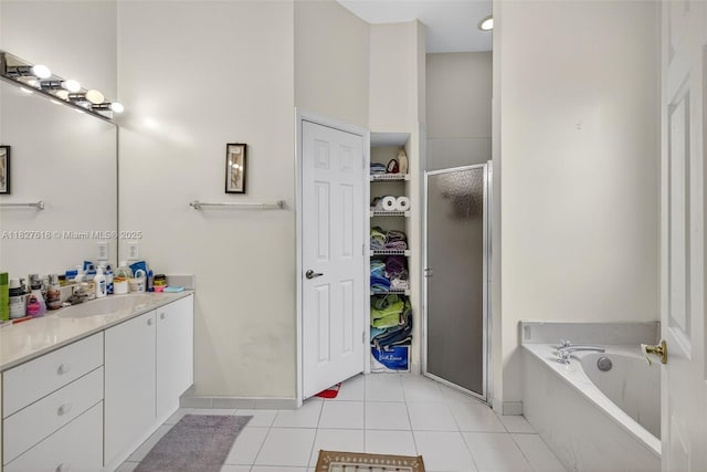 7095 E Tropical Way, Plantation, FL 33317 - bathroom featuring vanity, a shower stall, a garden tub, tile patterned flooring, and a walk in closet
