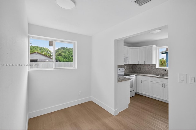 11504 SW 226th St, Miami, FL 33170 - kitchen with white appliances, white cabinets, light wood-style flooring, and backsplash