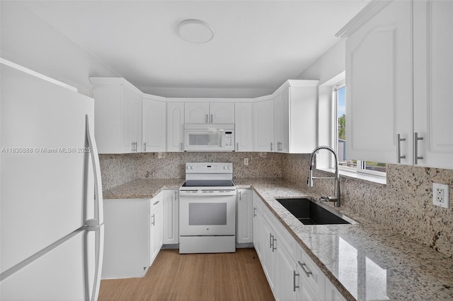 11504 SW 226th St, Miami, FL 33170 - kitchen with white appliances, white cabinets, and backsplash