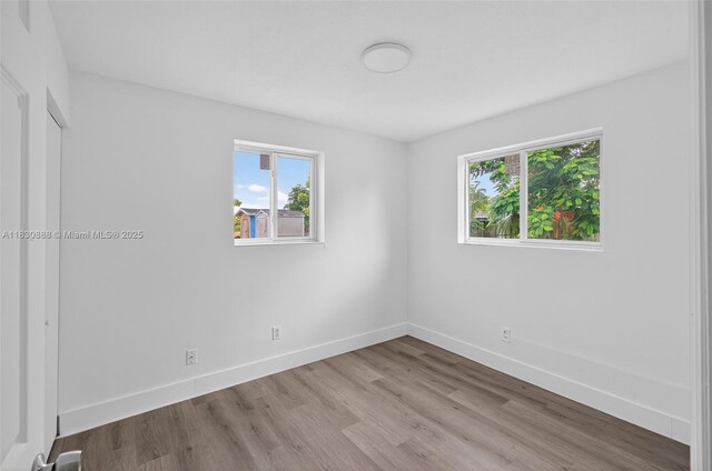 11504 SW 226th St, Miami, FL 33170 - spare room featuring plenty of natural light and wood finished floors