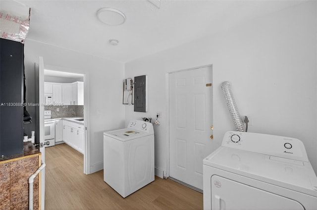 11504 SW 226th St, Miami, FL 33170 - laundry room featuring electric panel, light wood-type flooring, and separate washer and dryer