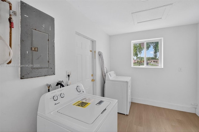 11504 SW 226th St, Miami, FL 33170 - laundry room featuring washer hookup, light wood-style floors, electric panel, and attic access