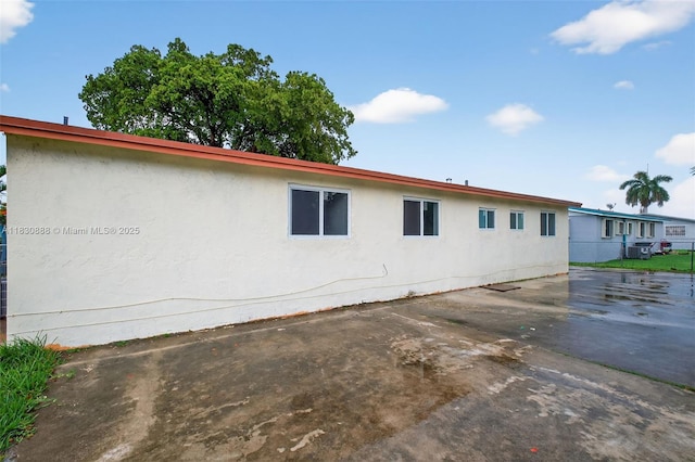 11504 SW 226th St, Miami, FL 33170 - view of property exterior featuring a central air condition unit and stucco siding