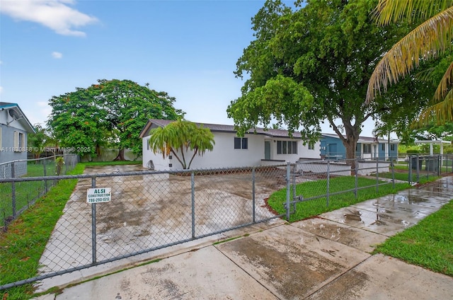 11504 SW 226th St, Miami, FL 33170 - view of front of house with a fenced front yard and stucco siding