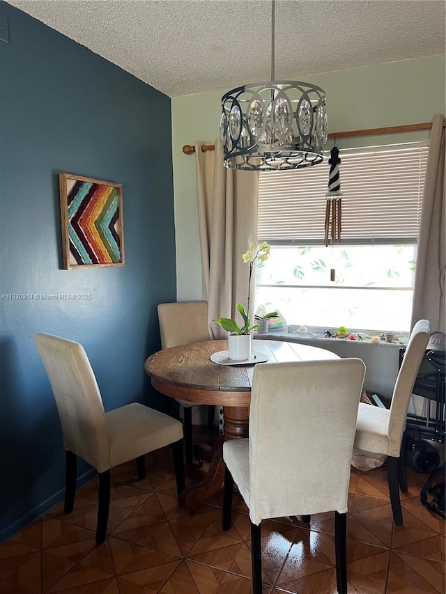 4143 N Ocean Blvd Unit 303, Fort Lauderdale, FL 33308 - dining area featuring a chandelier and a textured ceiling