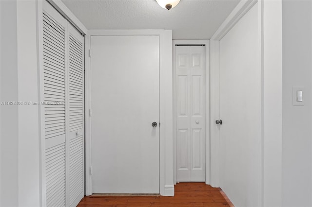 945 NE 34th Ave Unit 103, Homestead, FL 33033 - corridor with wood finished floors and a textured ceiling