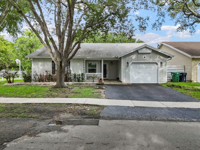 14913 SW 143rd Ct, Miami, FL 33186 - ranch-style house featuring driveway, an attached garage, and covered porch
