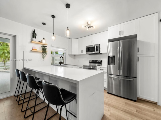 14913 SW 143rd Ct, Miami, FL 33186 - kitchen featuring appliances with stainless steel finishes, plenty of natural light, a peninsula, and a breakfast bar