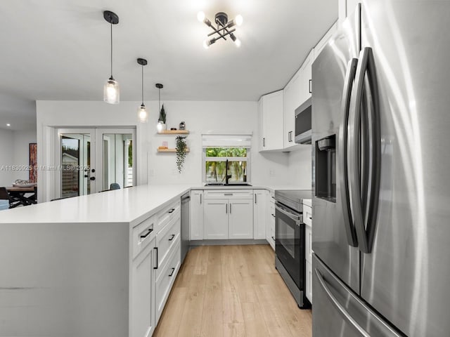 14913 SW 143rd Ct, Miami, FL 33186 - kitchen featuring appliances with stainless steel finishes, french doors, a peninsula, light wood-style flooring, and open shelves