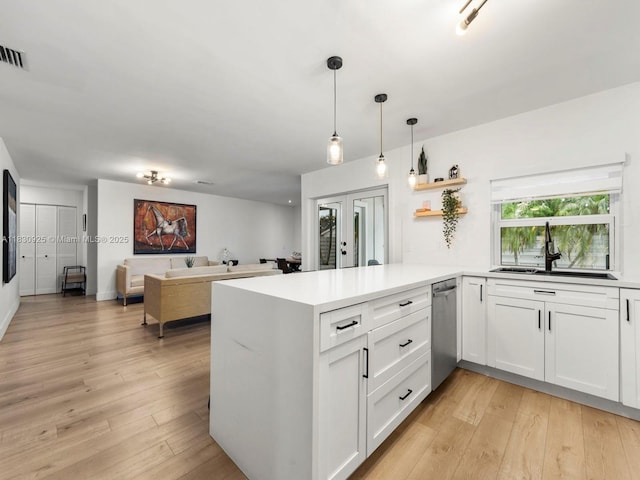14913 SW 143rd Ct, Miami, FL 33186 - kitchen featuring stainless steel dishwasher, french doors, a peninsula, and white cabinetry
