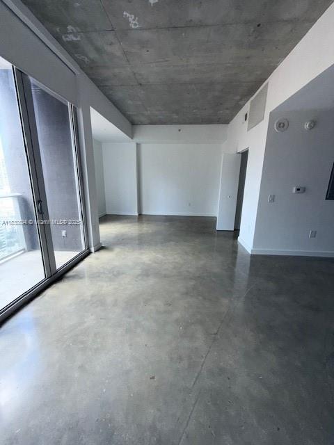 151 SE 1st St Unit 1607, Miami, FL 33131 - spare room featuring finished concrete flooring and baseboards