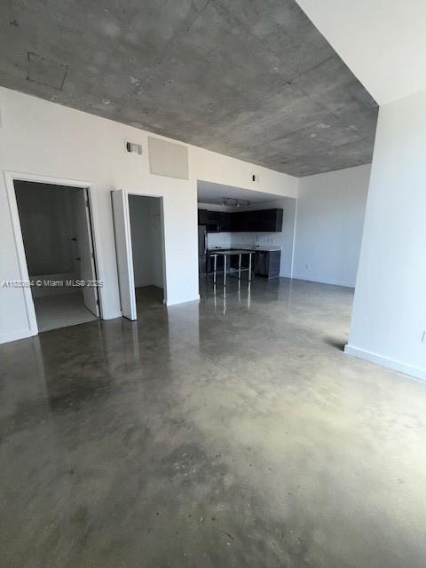 151 SE 1st St Unit 1607, Miami, FL 33131 - unfurnished living room featuring concrete floors
