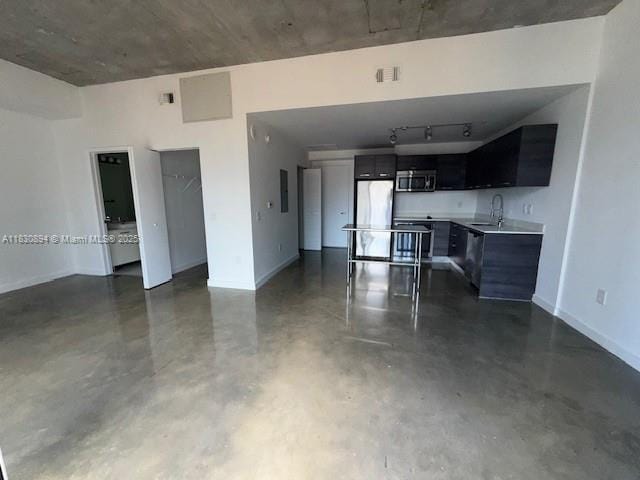 151 SE 1st St Unit 1607, Miami, FL 33131 - kitchen featuring stainless steel microwave, fridge, concrete flooring, light countertops, and dark cabinetry