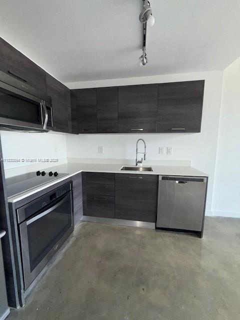 151 SE 1st St Unit 1607, Miami, FL 33131 - kitchen with appliances with stainless steel finishes, modern cabinets, finished concrete floors, light countertops, and dark cabinetry