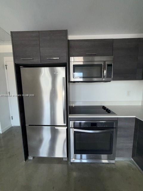 151 SE 1st St Unit 1607, Miami, FL 33131 - kitchen featuring stainless steel appliances, modern cabinets, light countertops, and finished concrete floors