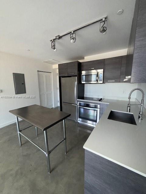 151 SE 1st St Unit 1607, Miami, FL 33131 - kitchen with appliances with stainless steel finishes, electric panel, track lighting, and modern cabinets