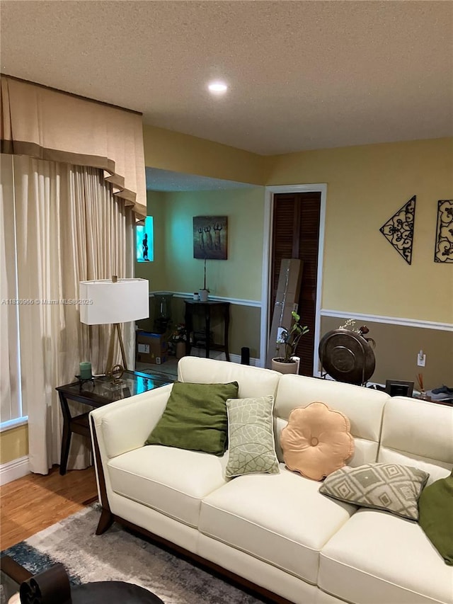 20950 N Miami Ave, Miami Gardens, FL 33169 - living room featuring a textured ceiling, wood finished floors, and recessed lighting