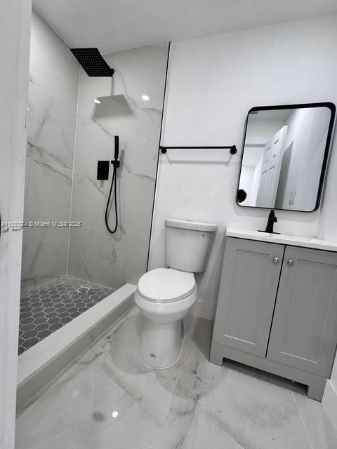 1108 SW 22nd Ave, Fort Lauderdale, FL 33312 - full bathroom with a marble finish shower, vanity, and marble look tiles