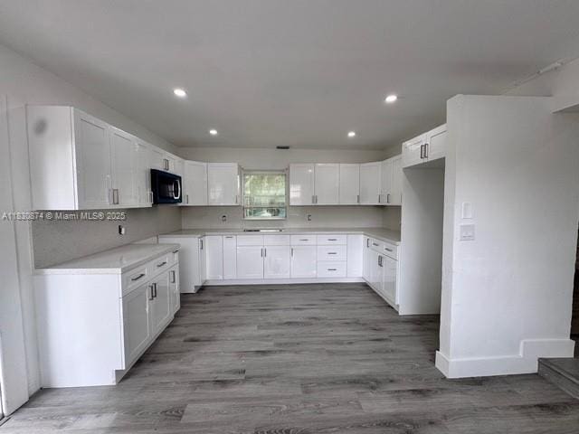 1108 SW 22nd Ave, Fort Lauderdale, FL 33312 - kitchen featuring black microwave, white cabinetry, recessed lighting, wood finished floors, and light countertops