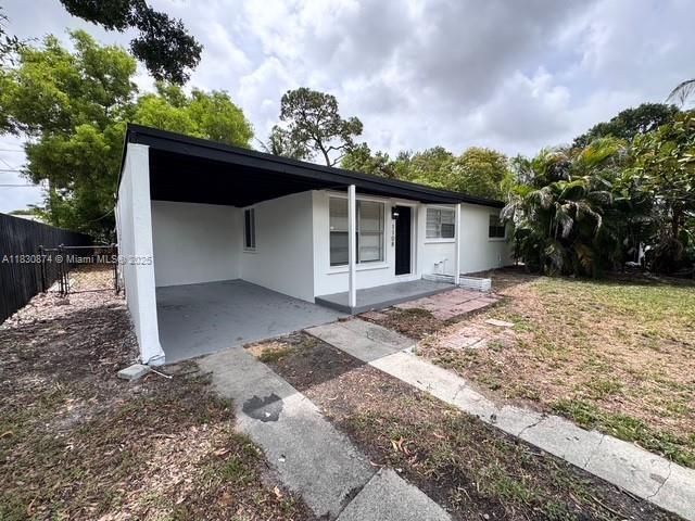 1108 SW 22nd Ave, Fort Lauderdale, FL 33312 - view of front of house featuring a carport and stucco siding