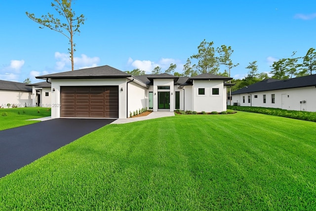 3324 NE 27, Naples, FL 34120 - view of front of home with an attached garage, stucco siding, a front lawn, and asphalt driveway