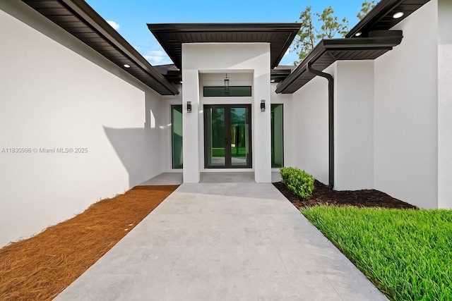 3324 NE 27, Naples, FL 34120 - doorway to property featuring stucco siding and french doors