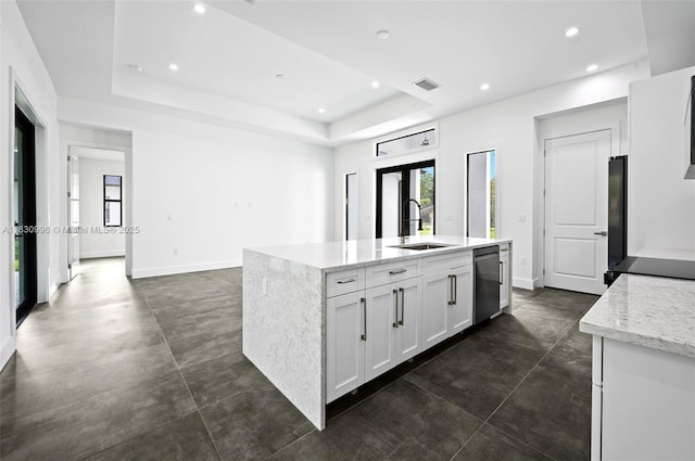 3324 NE 27, Naples, FL 34120 - kitchen featuring dishwasher, concrete floors, a raised ceiling, a center island with sink, and recessed lighting