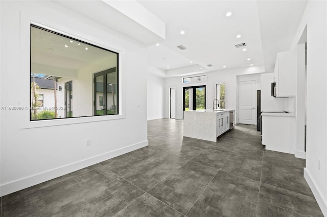 3324 NE 27, Naples, FL 34120 - unfurnished living room with recessed lighting and concrete flooring