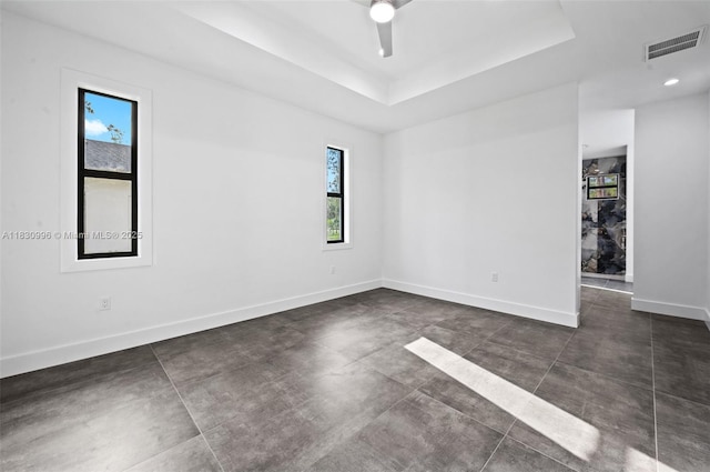 3324 NE 27, Naples, FL 34120 - unfurnished room with a ceiling fan, concrete flooring, and a tray ceiling