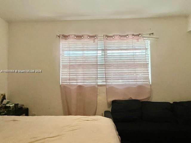 12890 NE 8th Ave Unit 102, North Miami, FL 33161 - bedroom featuring multiple windows