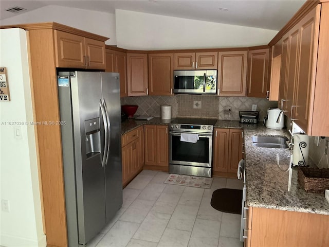 651 SW 176th Ave, Pembroke Pines, FL 33029 - kitchen with stainless steel appliances, lofted ceiling, stone counters, tasteful backsplash, and light marble finish floors