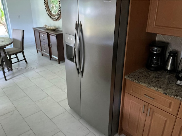 651 SW 176th Ave, Pembroke Pines, FL 33029 - kitchen featuring stainless steel fridge, stone counters, and tasteful backsplash
