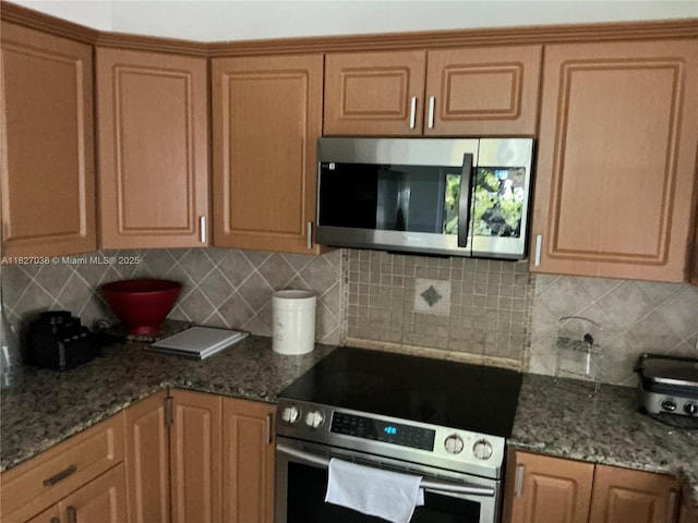 651 SW 176th Ave, Pembroke Pines, FL 33029 - kitchen with appliances with stainless steel finishes, decorative backsplash, and stone countertops