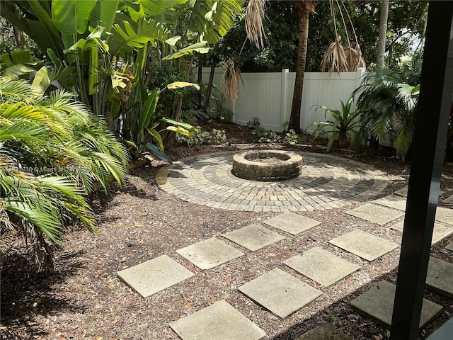 651 SW 176th Ave, Pembroke Pines, FL 33029 - view of yard featuring an outdoor fire pit and a patio area