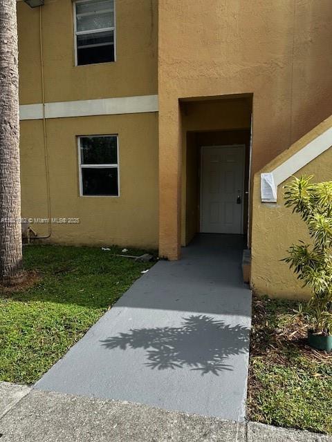 1428 SE 4th Ave Unit 254, Deerfield Beach, FL 33441 - view of exterior entry with stucco siding