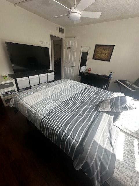 1428 SE 4th Ave Unit 254, Deerfield Beach, FL 33441 - bedroom with wood finished floors and a ceiling fan