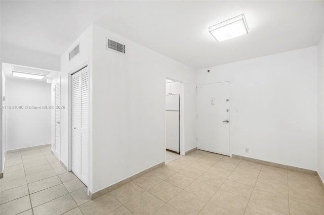 1200 W Ave Unit 1419, Miami Beach, FL 33139 - empty room with light tile patterned floors and baseboards