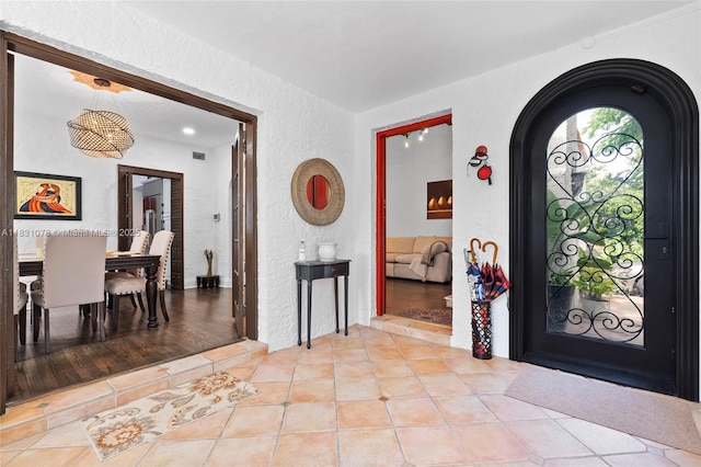 1320 Obispo Ave, Coral Gables, FL 33134 - entryway featuring a textured wall, arched walkways, and tile patterned flooring