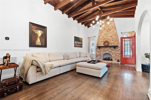 1320 Obispo Ave, Coral Gables, FL 33134 - living area featuring high vaulted ceiling, hardwood / wood-style flooring, a chandelier, a stone fireplace, and arched walkways