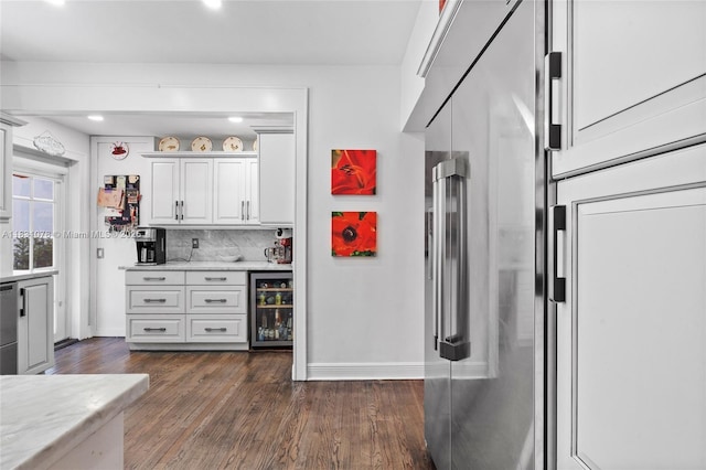 1320 Obispo Ave, Coral Gables, FL 33134 - kitchen with beverage cooler, dark wood finished floors, tasteful backsplash, white cabinetry, and recessed lighting