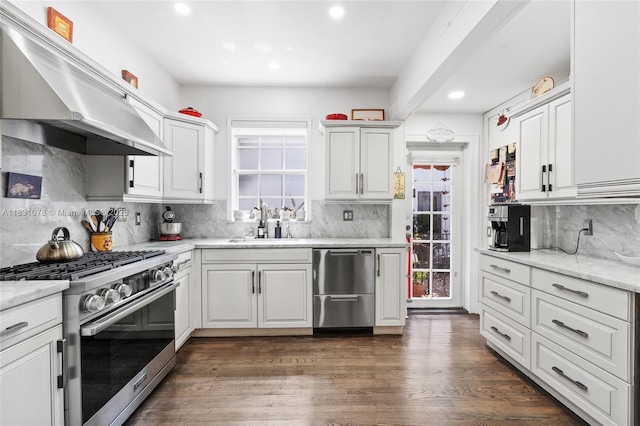 1320 Obispo Ave, Coral Gables, FL 33134 - kitchen featuring appliances with stainless steel finishes, wall chimney exhaust hood, tasteful backsplash, recessed lighting, and white cabinetry
