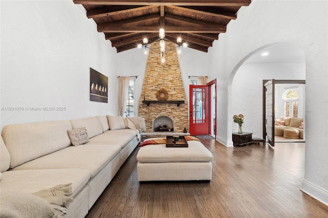1320 Obispo Ave, Coral Gables, FL 33134 - living room featuring arched walkways, a chandelier, wood finished floors, beam ceiling, and high vaulted ceiling