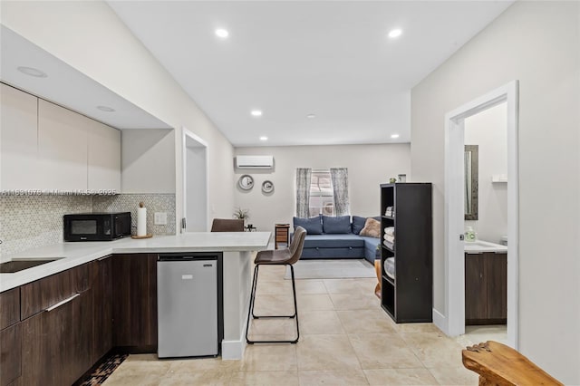1320 Obispo Ave, Coral Gables, FL 33134 - kitchen with black microwave, modern cabinets, light countertops, an AC wall unit, and dark brown cabinets