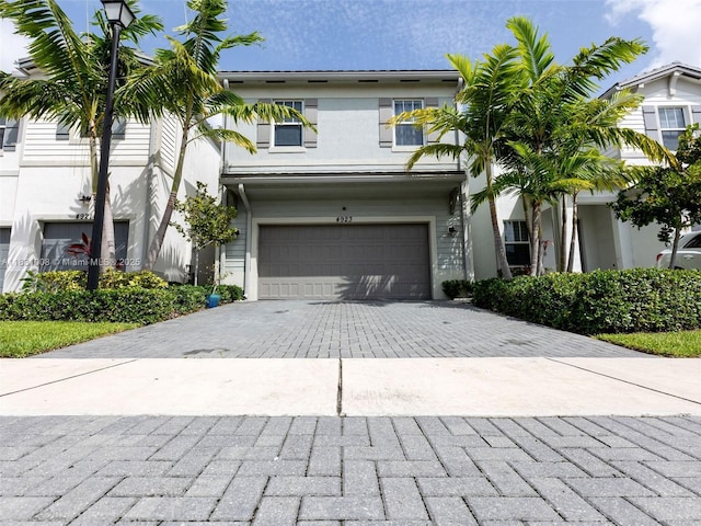 4923 NW 48th Ter, Tamarac, FL 33319 - view of front of property with a garage, decorative driveway, and stucco siding