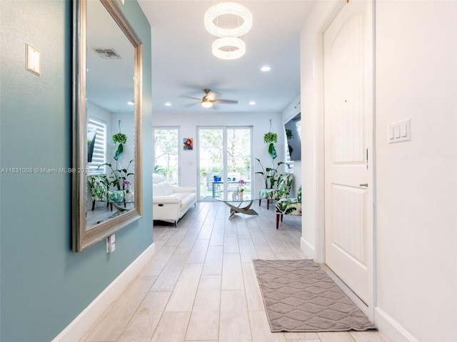 4923 NW 48th Ter, Tamarac, FL 33319 - hallway with light wood-type flooring, a chandelier, and recessed lighting
